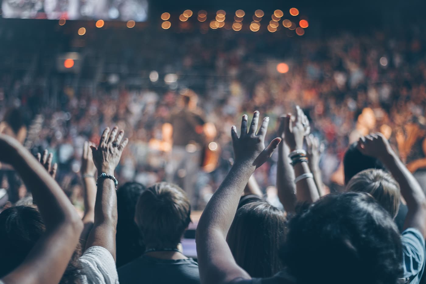 Revival Center congregation worshipping with hands raised